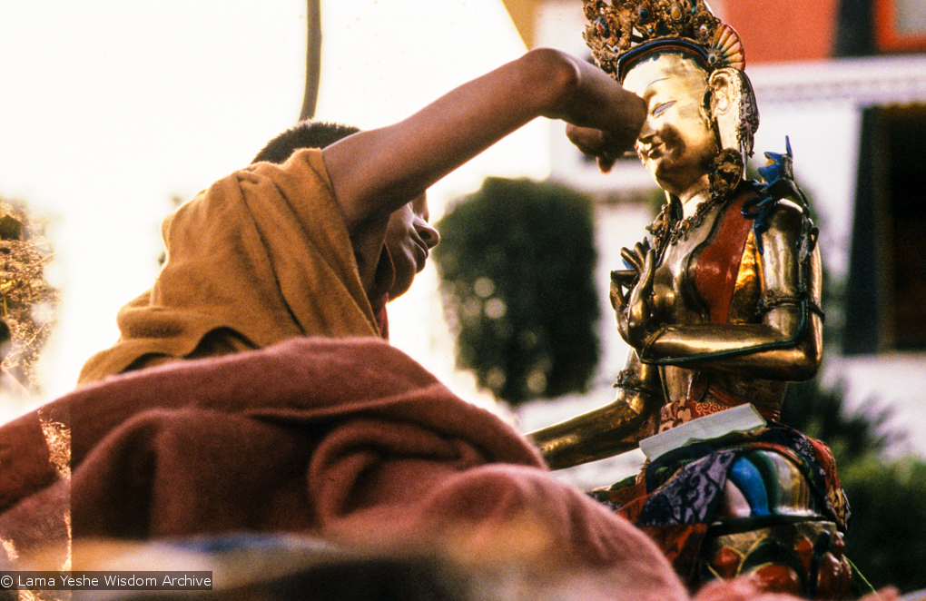 (06482_sl.JPG) Lama Zopa Rinpoche painting Tara, Kopan Monastery, Nepal, 1976. Lama Yeshe sent Max Mathews to buy a large Tara statue in Kathmandu, which was eventually placed in a glass-fronted house on a pedestal overlooking a triangular pond that was built under the ancient bodhi tree in front of the gompa, Kopan Monastery, Nepal. Photo by Peter Iseli.