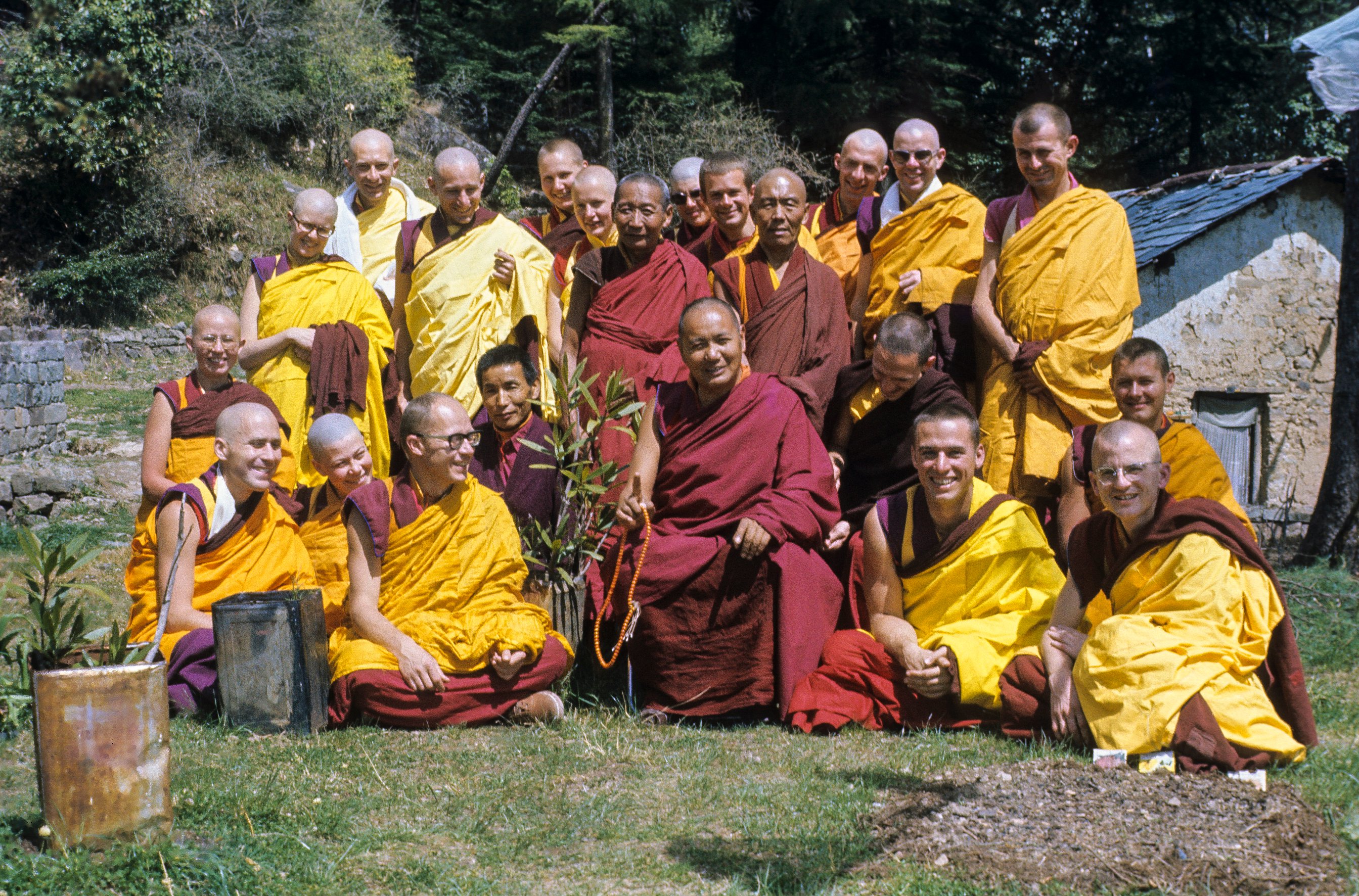 (09493_sl.JPG) Ordination group with Lama Yeshe, 1976. Front row: George Churinoff (Karin Valham behind him), Elisabeth Drukier, Dieter Kratzer, (Losang Nyima behind him), Lama Yeshe, Thubten Pende (Jim Dougherty), Steve Malasky (Steve Pearl). Gareth Sparham and Marcel Bertels are behind Pende and Steve. Back row (standing): Margaret McAndrew, Adrian Feldmann (Thubten Gyatso), Scott Brusso, Ursula Bernis, Wendy Finster, unknown tibetan monk, in back Angeles de la Torre, Jeffery Webster, unknown 