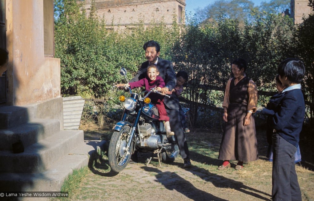 (09619_sl.JPG) Jampa Trinley and Daja Meston (Thubten Wangchuk) on a motor cycle, at their house in Kathmandu, Nepal, 1975. Kelsang Puntsog Rinpoche, the son of Lama Yeshe's old friend Jampa Trinley, was later recognized to be the reincarnation of Geshe Ngawang Gendun, one of Lama's teachers.