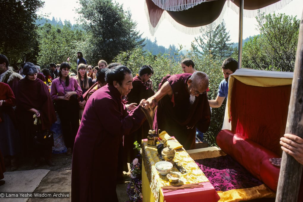 (10063_sl.JPG) Zong Rinpoche attended to by Geshe Gyeltsen at the cremation of Lama Yeshe at Vajrapani Institute, California in March of 1984. Photo by Ricardo de Aratanha.