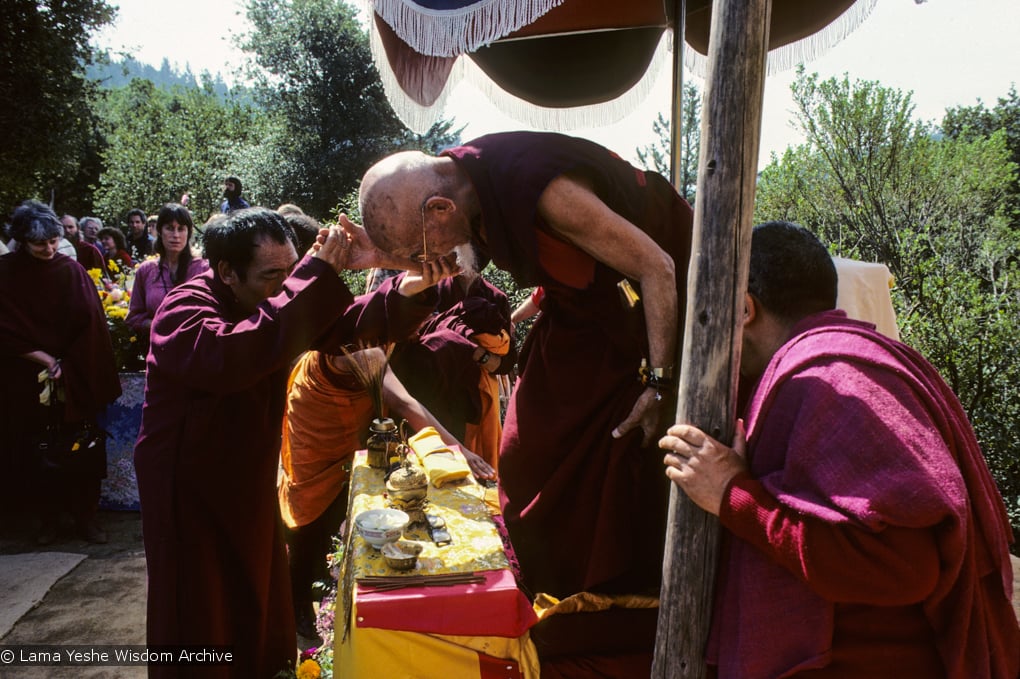 (10064_sl.JPG) Zong Rinpoche attended to by Geshe Gyeltsen at the cremation of Lama Yeshe at Vajrapani Institute, California in March of 1984. Photo by Ricardo de Aratanha.