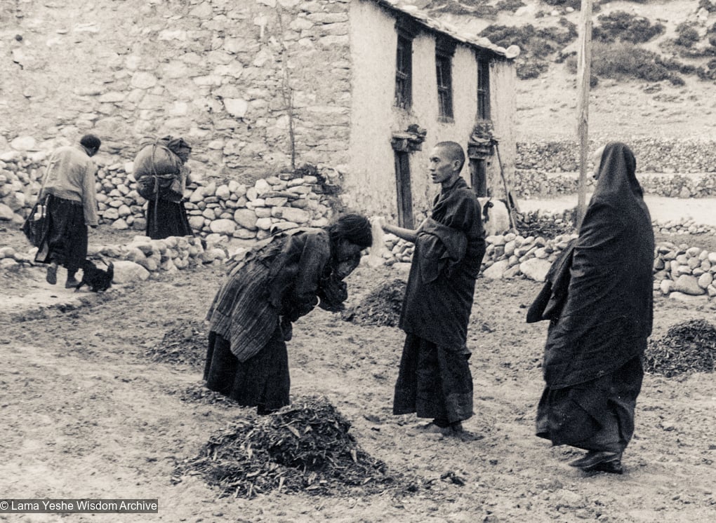 (12033_pr-3.psd) Lama Zopa Rinpoche (center) blesses a mother and child as Lama Yeshe looks on at at Thangme. Photo from the first trek to Lawudo Retreat Center in Nepal, spring of 1969. Lawudo was the hermitage of the Lawudo Lama, the former incarnation of Lama Zopa Rinpoche. Photos by George Luneau.