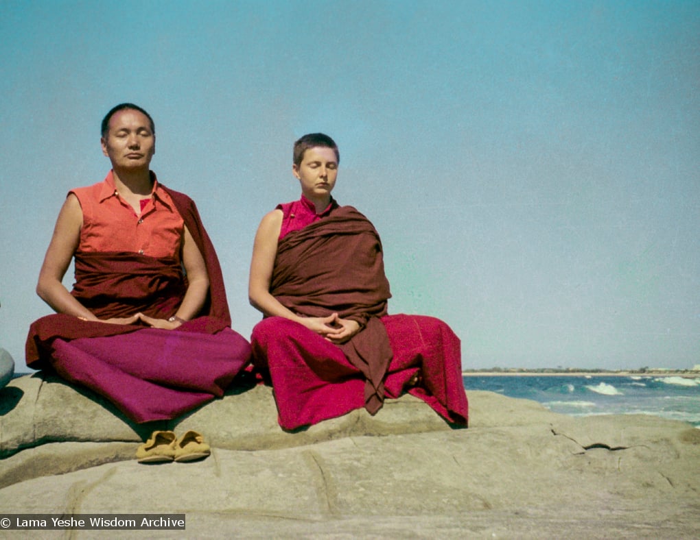 (15850_ng.tif) Lama and Yeshe Khadro meditating by the ocean, Maroochydore, Australia, 1974. The lamas took a day off during the Diamond Valley course to go to the beach in Tom Vichta's van. Everyone got out to enjoy the view from the cliffs, but Lama Yeshe ran straight down to the water's edge, hitched up his robes, and waded in, splashing about with delight.