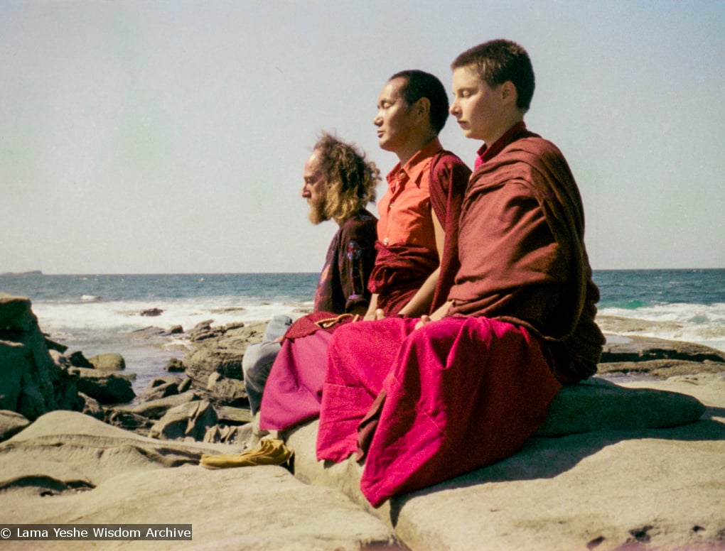 (15851_ng.tif) Lama Yeshe with Yeshe Khadro and Chamba Lane meditating by the ocean, Maroochydore, Australia, 1974. The lamas took a day off during the Diamond Valley course to go to the beach in Tom Vichta's van. Everyone got out to enjoy the view from the cliffs, but Lama Yeshe ran straight down to the water's edge, hitched up his robes, and waded in, splashing about with delight.