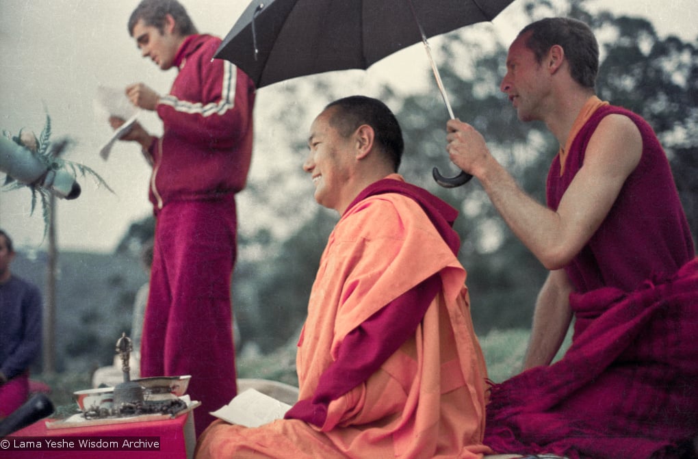 (16051_ng-2.psd) Lama Yeshe doing the Fire Puja (with Jhampa Zangpo (Mark Shaneman) holding umbrella) at Chenrezig Institute, Australia, 1976.