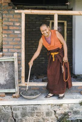 Lama Yeshe mixing cement for ongoing construction projects at Kopan Monastery, Nepal, 1974.