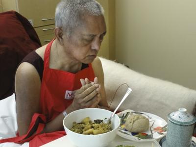 Rinpoche offering food while in hospital in Australia after manifesting a stroke in April 2011. Photo: Ven. Holly Ansett.