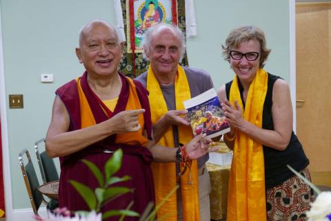 Nick Ribush and Wendy Cook present one of LYWA's latest publications to Lama Zopa Rinpoche, 2016. Photo: Ven. Roger Kunsang.