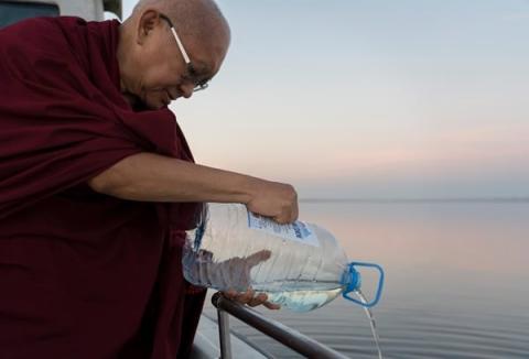 Rinpoche pouring blessed water into the sea to bless all beings in the Caspian Sea, Russia, October 2019. Photo: Ven. Lobsang Sherab.