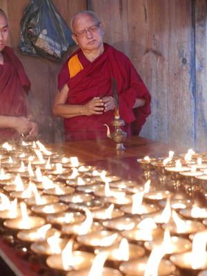 Lama Zopa Rinpoche offering butter lamps at Kyichu Lhakhang, a temple in Bhutan. Photo: Roger Kunsang.