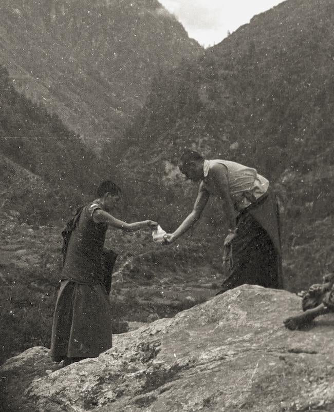 Lama offering Rinpoche candy, leaving Namche Bazaar on the way to Lawudo, 1973. Photo: Nick Ribush
