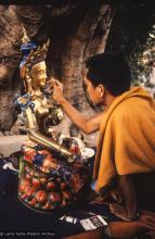 (06481_sl.JPG) Lama Zopa Rinpoche painting Tara, Kopan Monastery, Nepal, 1976. Lama Yeshe sent Max Mathews to buy a large Tara statue in Kathmandu, which was eventually placed in a glass-fronted house on a pedestal overlooking a triangular pond that was built under the ancient bodhi tree in front of the gompa, Kopan Monastery, Nepal. Photo by Peter Iseli.