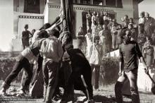 (15155_ng.psd) Raising the prayer flag pole at Kopan Monastery, Nepal, 1972. In attendance are some Mount Everest Center monks and students from the third Kopan course. Nick Ribush, an early student of the Lamas, is at the front right.