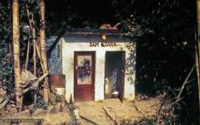 (15187_pr.psd) The outhouse labeled Sam-Sara at Kopan Monastery, Nepal, 1973. A pun on the sanskrit term "samsara" which refers to the beginningless, recurring cycle of death and rebirth fraught with suffering. Photo by Lynda Millspaugh.