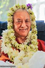 (15404_ud.JPG) Lama Zopa Rinpoche posing with flowers, 2010.