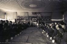 (15882_sl.psd) Photo of the lamas and sangha doing puja in the tent, Kopan Monastery, Nepal, 1974. For the Seventh Meditation Course a huge Indian wedding tent replaced the dusty burlap-walled tent.