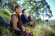 (15969_sl.JPG) Lama Yeshe, Beatrice Ribush, and Lama Zopa Rinpoche in meditation. On Saka Dawa (the celebration of Buddha's birth, enlightenment, and death), Lama Yeshe asked everyone to come outside after a Guru Puja for a meditation on the hill behind the gompa. Chenrezig Institute, Australia, May 25, 1975. Photo by Wendy Finster.