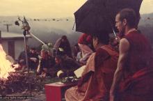 (16052_ng-2.psd) Lama Yeshe doing the Fire Puja (with Jhampa Zangpo (Mark Shaneman) holding umbrella) at Chenrezig Institute, Australia, 1976.