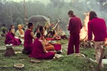 (16053_ng-2.psd) Lama Yeshe doing the Fire Puja (with Jhampa Zangpo (Mark Shaneman) holding the umbrella, Yeshe Khadro (Marie Obst) sitting to his right and Anila Ann sitting to the left, Chenrezig Institute, Australia, 1976.