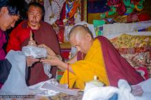 (21772_pr.jpg) Lama Zopa Rinpoche making Mandala offering, 1990. Photo by Merry Colony.