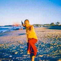 (00079_ud.jpg) Lama Yeshe dancing/debating on the beach after the month-long course at Chenrezig Institute, Australia, 1975. Photo by Anila Ann.