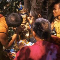 (06476_sl.JPG) Lama Yeshe painting Tara, Kopan Monastery, Nepal, 1976. Lama Yeshe sent Max Mathews to buy a large Tara statue in Kathmandu, which was eventually placed in a glass-fronted house on a pedestal overlooking a triangular pond that was built under the ancient bodhi tree in front of the gompa, Kopan Monastery, Nepal. Photo by Peter Iseli.