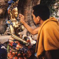 (06481_sl.JPG) Lama Zopa Rinpoche painting Tara, Kopan Monastery, Nepal, 1976. Lama Yeshe sent Max Mathews to buy a large Tara statue in Kathmandu, which was eventually placed in a glass-fronted house on a pedestal overlooking a triangular pond that was built under the ancient bodhi tree in front of the gompa, Kopan Monastery, Nepal. Photo by Peter Iseli.