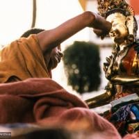 (06482_sl.JPG) Lama Zopa Rinpoche painting Tara, Kopan Monastery, Nepal, 1976. Lama Yeshe sent Max Mathews to buy a large Tara statue in Kathmandu, which was eventually placed in a glass-fronted house on a pedestal overlooking a triangular pond that was built under the ancient bodhi tree in front of the gompa, Kopan Monastery, Nepal. Photo by Peter Iseli.