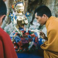 (12930_sl.tif) Lama Zopa Rinpoche painting Tara, Kopan Monastery, Nepal, 1976. Lama Yeshe sent Max Mathews to buy a large Tara statue in Kathmandu, which was eventually placed in a glass-fronted house on a pedestal overlooking a triangular pond that was built under the ancient bodhi tree in front of the gompa, Kopan Monastery, Nepal. Photo by Peter Iseli.