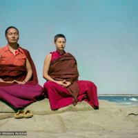 (15850_ng.tif) Lama and Yeshe Khadro meditating by the ocean, Maroochydore, Australia, 1974. The lamas took a day off during the Diamond Valley course to go to the beach in Tom Vichta's van. Everyone got out to enjoy the view from the cliffs, but Lama Yeshe ran straight down to the water's edge, hitched up his robes, and waded in, splashing about with delight.