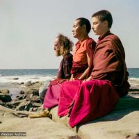 (15851_ng.tif) Lama Yeshe with Yeshe Khadro and Chamba Lane meditating by the ocean, Maroochydore, Australia, 1974. The lamas took a day off during the Diamond Valley course to go to the beach in Tom Vichta's van. Everyone got out to enjoy the view from the cliffs, but Lama Yeshe ran straight down to the water's edge, hitched up his robes, and waded in, splashing about with delight.