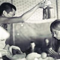 (15886_sl.psd) Lama Zopa Rinpoche blesses Anne Ogburn during a wedding in the meditation tent, Kopan Monastery, Nepal, 1974.