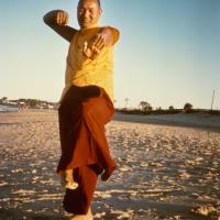 (15928_pr.psd) Lama Yeshe dancing/debating on the beach after the month-long course at Chenrezig Institute, Australia, 1975. Photo by Anila Ann.