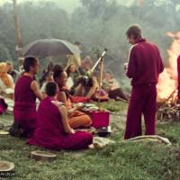 (16053_ng-2.psd) Lama Yeshe doing the Fire Puja (with Jhampa Zangpo (Mark Shaneman) holding the umbrella, Yeshe Khadro (Marie Obst) sitting to his right and Anila Ann sitting to the left, Chenrezig Institute, Australia, 1976.