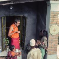 (16688_sl.tif) Adrian Feldmann (Ven Thubten Gyatso) treating local Nepali villagers outside the People's Clinic, Kopan Monastery, 1979.