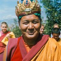 (16769_sl.tif) Lama Yeshe wearing a ceremonial crown of the five dhyani buddhas for the Tara statue procession, Kopan Monastery, Nepal, 1976. Behind him is Yeshe Khadro (Marie Obst) on the left and Wendy Finster and  Ngawang Khyentse on the right.