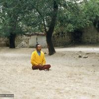 Lama Yeshe meditating at the site of his old room, Sera Monastery, Tibet, 1982.