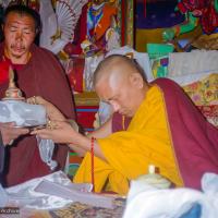 (21772_pr.jpg) Lama Zopa Rinpoche making Mandala offering, 1990. Photo by Merry Colony.