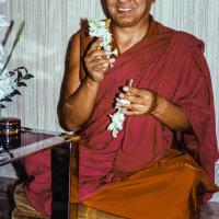 (21951_pr-3.jpg) Lama Yeshe giving the Vajrasattva empowerment, Alhambra, Spain, 1982. "That evening, Lama Yeshe was about to give some students a Vajrasattva empowerment in his room at the Granada Palace Hotel when it was found that his dorje and bell had been left  in Barcelona. No matter, Lama picked up two tuberose spikes and used those instead. At exactly those moments in the ritual when music is offered and the bell usually rung, the bells in the church next door began to chime— every time