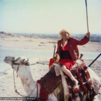 (21957_pr-3.tif) Lama Yeshe riding a camel in Giza, an Egyptian city on the west bank of the Nile, near Cairo, 1983.