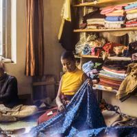 (39331_sl-3.jpg) Max Mathews with fabric for her clothing business, New Delhi, 1976.