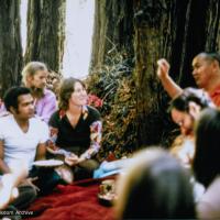 (39354_ud-3.psd) Lama and students on Vajrapani land, CA, 1977. Lama asked where the property boundary was and went running up to the highest point on a steep ridge. In some places the land was almost vertical. Lama gave a teaching then and there in a small redwood grove on the property. Walter Klopfenstein in purple shirt. Carol Fields (donor)