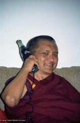 (08526_ng.JPG) Lama Zopa Rinpoche at Doc Wight’s place in Adelaide holding a phone made from a Coke bottle. Taken during Rinpoche’s teaching tour of Australia in 1983. LYWA collection.