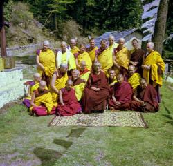 (09311_ng.JPG) Ordination group with HH Trijang Rinpoche, 1976. Front row: Karin Valham, Lama Zopa Rinpoche, HH Trijang Rinpoche seated, Lama Yeshe, Geshe Jampa Wangdu. Second row: Margaret McAndrew, Angeles de la Torre, Steve Malasky (Steve Pearl), Wendy Finster, Thubten Pende (Jim Dougherty), Dieter Kratzer. Standing: Elisabeth Drukier, Scott Brusso, Roger Wheeler, Jeffery Webster, Marcel Bertels, John Feuille, Adrian Feldmann (Thubten Gyatso), Peter Kedge, Gareth Sparham, George Churinoff.