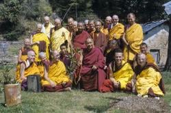 (09493_sl.JPG) Ordination group with Lama Yeshe, 1976. Front row: George Churinoff (Karin Valham behind him), Elisabeth Drukier, Dieter Kratzer, (Losang Nyima behind him), Lama Yeshe, Thubten Pende (Jim Dougherty), Steve Malasky (Steve Pearl). Gareth Sparham and Marcel Bertels are behind Pende and Steve. Back row (standing): Margaret McAndrew, Adrian Feldmann (Thubten Gyatso), Scott Brusso, Ursula Bernis, Wendy Finster, unknown tibetan monk, in back Angeles de la Torre, Jeffery Webster, unknown 