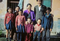 (09626_sl.JPG) Jampa Trinley with his wife, Ngawang, their family and Daja Meston (Thubten Wangchuk) in the front, at their house in Kathmandu, Nepal, 1975. Front row, left to right: Wangmo, Daja Meston (Thubten Wangchuk), Tsewang, Tashi. Back row, left to right: Nyidro, Auntie Tham Chola, Ngawang, Jampa Trinley.   Kelsang Puntsog Rinpoche, the son of Lama Yeshe's old friend Jampa Trinley, was later recognized to be the reincarnation of Geshe Ngawang Gendun, one of Lama's teachers.