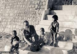 (11715_ud-3.psd) Lama Yeshe with Jhamba Drolkar (Lama's "daughter" at TCV) and two Nepalese boys on the front steps of Tibetan Children's Village, Dharamsala, India, 1973.