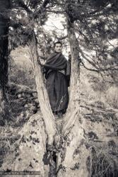 (15149_ng.tif) Lama Zopa Rinpoche posing in a tree, Lawudo Retreat Centre, Nepal,1972