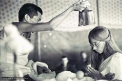 (15886_sl.psd) Lama Zopa Rinpoche blesses Anne Ogburn during a wedding in the meditation tent, Kopan Monastery, Nepal, 1974.