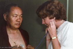 (23036_ng-3.psd) Jacie Keeley listening to Lama Yeshe's heart, Bodhgaya, India, 1982.